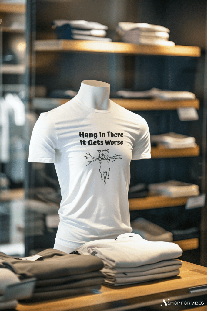 Hang In There, It Gets Worse cat t-shirt on display in a store