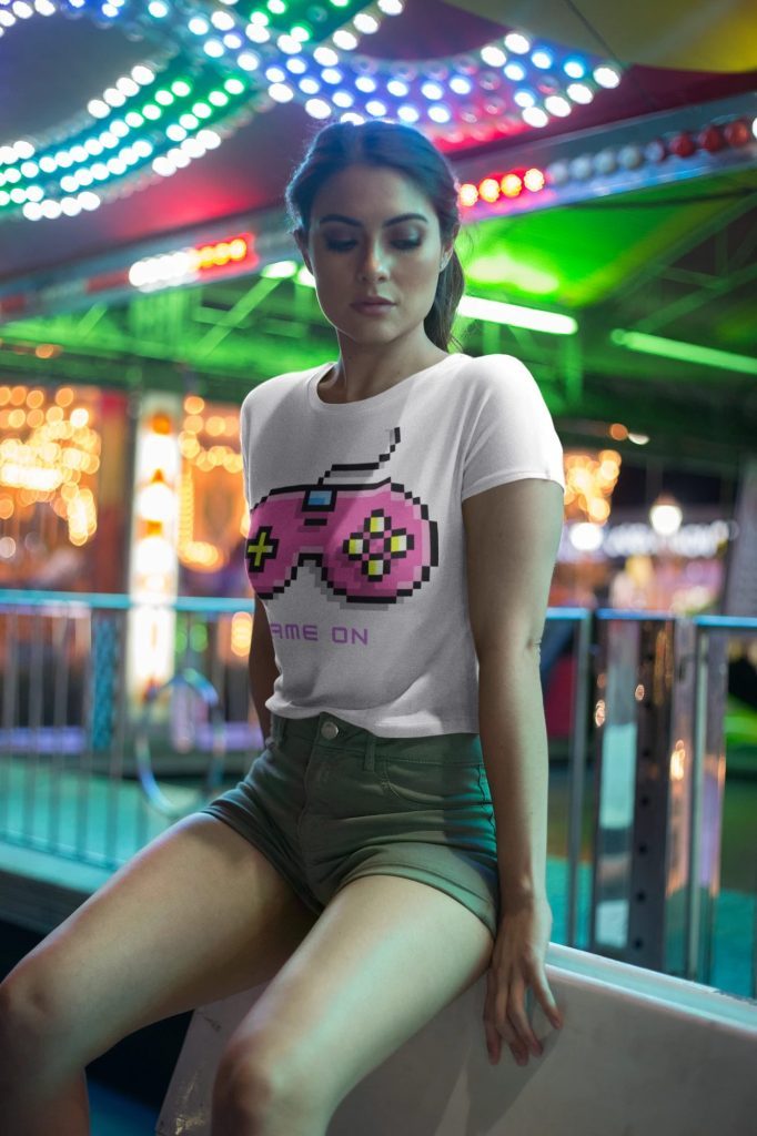 Woman wearing a Game On retro pixel controller crop tee at a carnival
